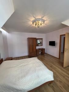 a bedroom with a bed and a ceiling at Garden Villa in Busko-Zdrój
