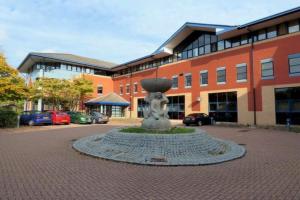 a building with a statue in front of a building at Comfortable Modern Apartment in Swindon, FREE parking sleeps up to 5 in Swindon