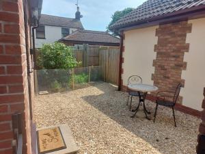 a patio with a table and chairs in a yard at Ash Cottage in Skegness