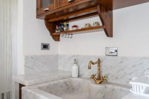 a bathroom with a sink and a faucet at Casa dei Renai by Rentbeat in Signa +19 photos