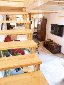 a living room with wooden shelves and a television at La Casina del Corral in Cangas de Onís