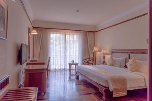 Postel nebo postele na pokoji v ubytování Sokha Angkor Resort