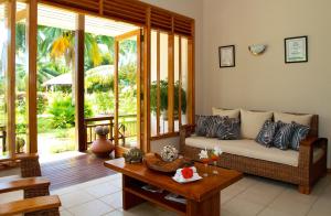 a living room with a couch and a table at Les Villas D'or in Baie Sainte Anne