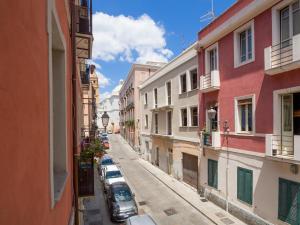 an empty street in a city with buildings at Casa Maretta in Cagliari