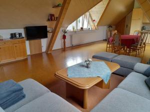 a living room with two couches and a table at Ferienwohnung Seeleshof in Geisa