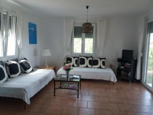Villa Kos في ماستيخاري: غرفة معيشة بسريرين وطاولة