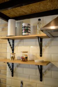 a kitchen with wooden shelves on a wall at Loft 2 in Kos