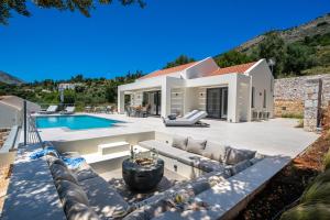 a villa with a swimming pool and a house at Villa Fortuna in Agia Effimia