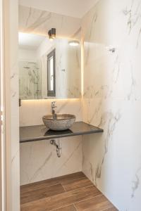 a bathroom with a sink and a mirror at Villa Fortuna in Ayia Evfimia