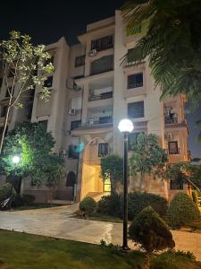 a building with a street light in front of it at Rehab City VIP Full Serviced Apartment الرحاب Guest satisfaction guaranteed in Cairo