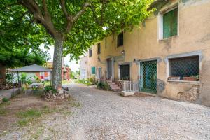 a building with a tree in front of it at Mas Guineu in Reus