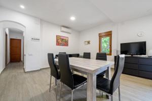 a dining room with a wooden table and chairs at Mas Guineu in Reus