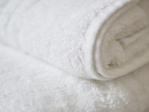 a close up of a white blanket on a bed at Bloc Hotel Birmingham in Birmingham