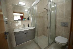 a bathroom with a shower and a sink and a toilet at POAL GROUP HOTELS in Bostancı