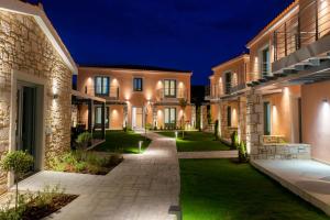 a courtyard of a villa at night at Nissos Apartments in Myrina