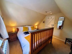 um quarto com uma cama grande e um espelho em Court Cottage, 2 bed period house em Sarre