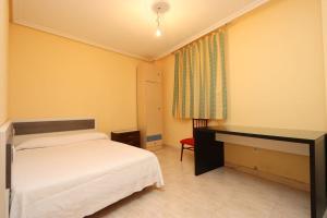 a hotel room with a bed and a desk at Apartamento DUQUES DE BÉJAR in Béjar