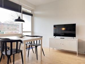 a dining room with a table and chairs and a tv at Studio Apartment In Herlev, Herlevgrdsvej 4, 3 in Herlev