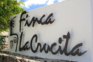 a sign for a hotel with the wordsfind the library at Villas Finca la Crucita by EscapeHome in Haría