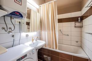 a bathroom with a sink and a tub and a toilet and a shower at Apartment for special getaway Rose in Pula +24 photos