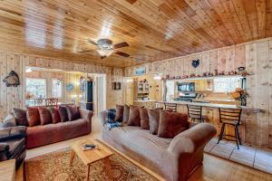 a living room with a couch and a ceiling fan at Hunsaker Hideaway in Running Springs