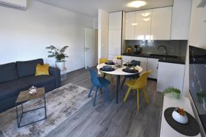 a living room with a couch and a table and chairs at Apartman Badi in Dugopolje