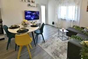 a living room with a table and a couch at Apartman Badi in Dugopolje