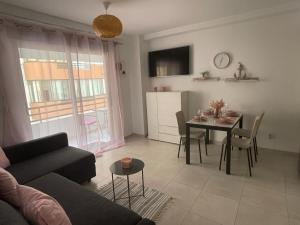 a living room with a couch and a table at Apartamento Calpe in Calpe +16 photos