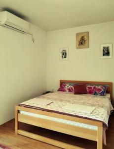 een slaapkamer met een bed met een houten frame bij S Kilaći in Mostar