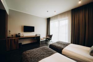 Postel nebo postele na pokoji v ubytování Lake Hill Karkonosze Resort & Spa + 37 fotografií