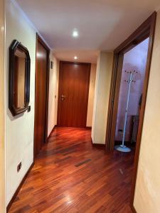 a hallway with a hard wood floor and a door at Siam Guest House Rome in Rome
