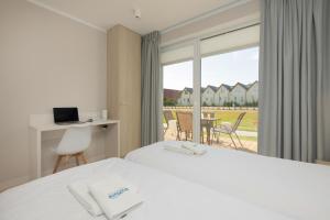 Postel nebo postele na pokoji v ubytování BURSZTYN - BERNSTEIN APARTMENTS