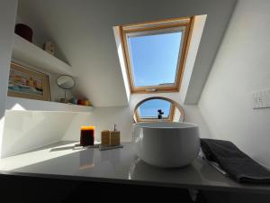 a bathroom with a round sink and a window at Bakke Design Loft in Sestri Levante +30 photos