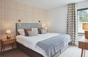 a bedroom with a large bed and a window at Beach House in Pennygown