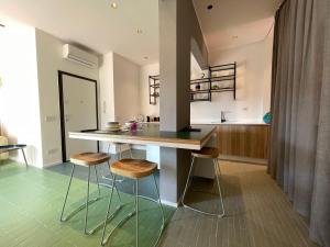 a kitchen with a counter and stools in a room at Bakke Design Loft in Sestri Levante