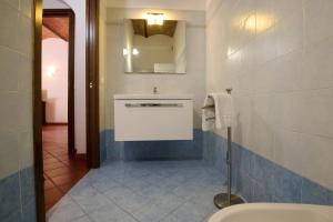 a bathroom with a toilet and a sink and a mirror at Antichi Palmenti - Erica in San Vincenzo +16 photos