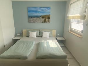 a bedroom with a bed and a picture of a beach at Downtown in Füssen