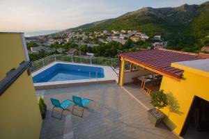 a balcony of a house with a swimming pool at Apartments Zora in Senj