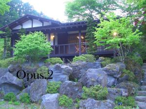 una casa con un jardín de rocas delante de ella en Shikitei, en Fujiyoshida