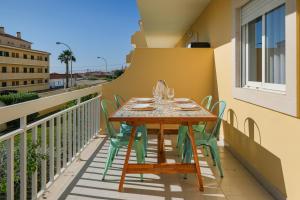 a table and chairs on the balcony of a building at Sea Lux Ericeira Beach in Ericeira