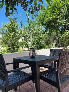 a black table with two chairs and a vase on it at Silver stars 1 in Zadar