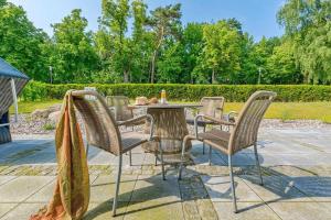 a table and chairs sitting on a patio at Villa Löwenstein in Kühlungsborn