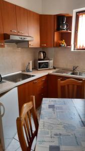 a kitchen with a table and a microwave at Apartment Aida in Medulin