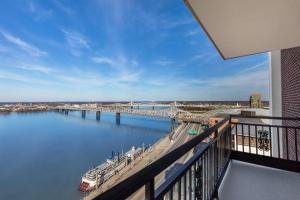 a balcony with a view of a river with a bridge at Galt House Hotel, A Trademark Collection Hotel in Louisville