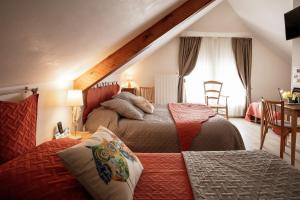 a bedroom with two beds and a window at Logis Hôtel Restaurant de la Poste et La Grange Détente, espace bien-être in Châteauneuf-de-Randon +42 photos