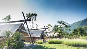 a church with a cross in the grass at Lala Mukha Tented Resort Khao Yai in Mu Si