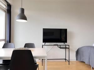 a living room with a table and a flat screen tv at Studio Apartment In Herlev 2 in Herlev