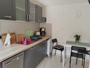 a kitchen with a sink and a table with chairs at Rügen Fewo 303 in Gingst