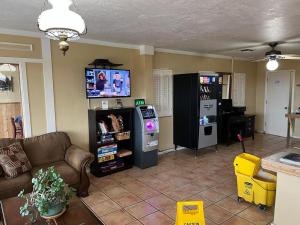 a living room with a couch and a video game at Landmark Lookout Lodge in Tombstone