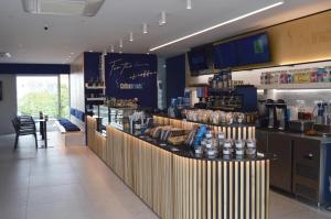 a restaurant with a counter and a bar with food at UC Hall Residence in Nicosia